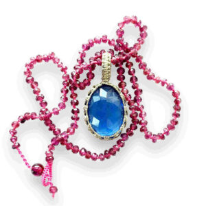 blue pendant on rhodolite necklace